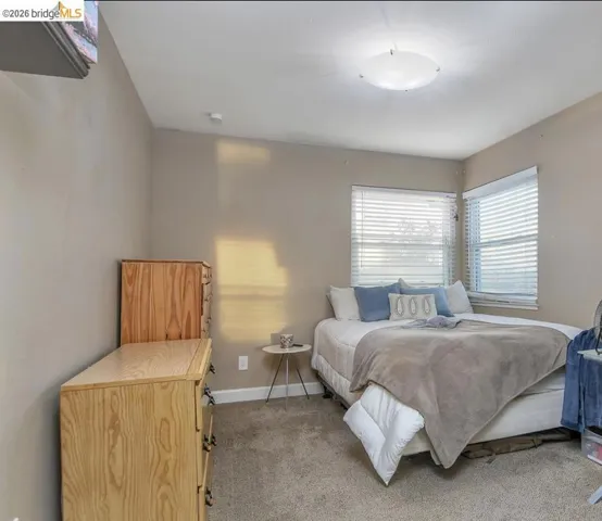 Carpeted bedroom featuring baseboards