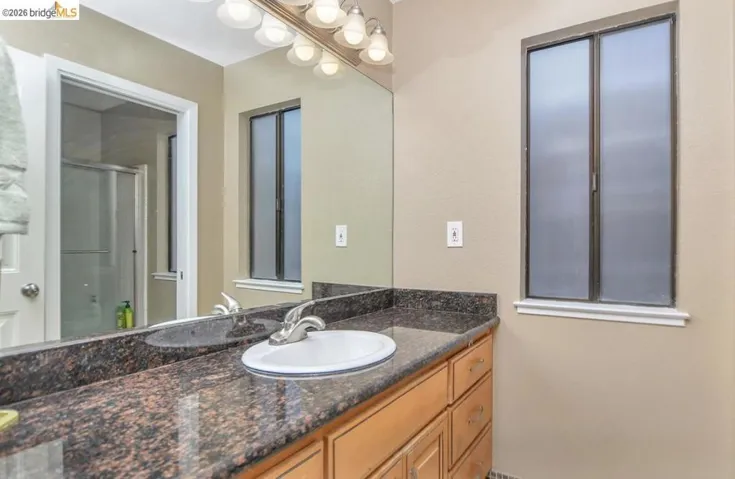 Bathroom featuring vanity and a stall shower
