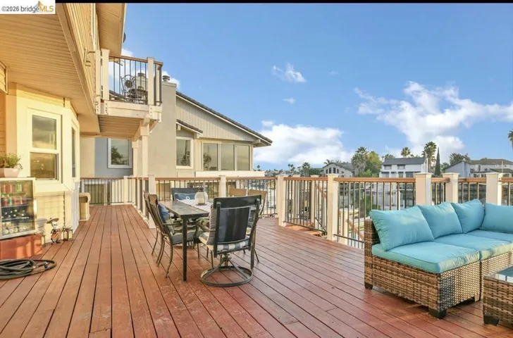 Wooden terrace featuring outdoor dining area, a residential view, and an outdoor living space