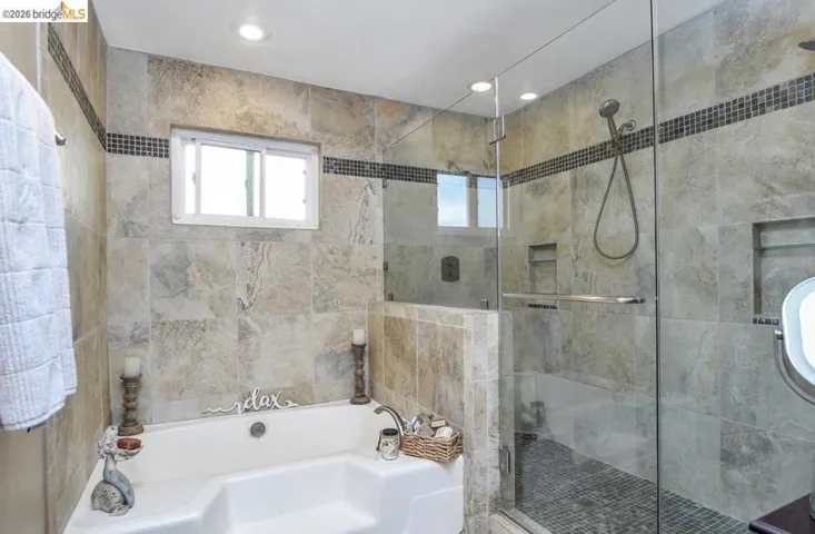 Bathroom featuring a garden tub, a shower stall, and recessed lighting