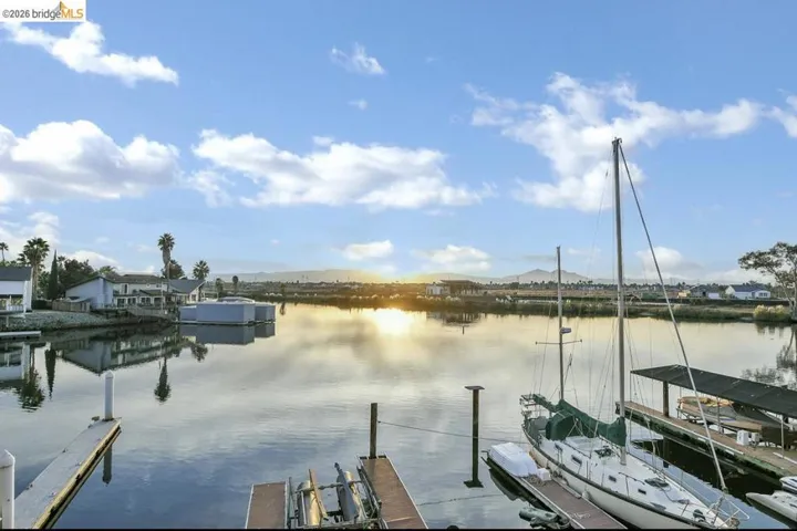 Dock area with a water view and boat lift