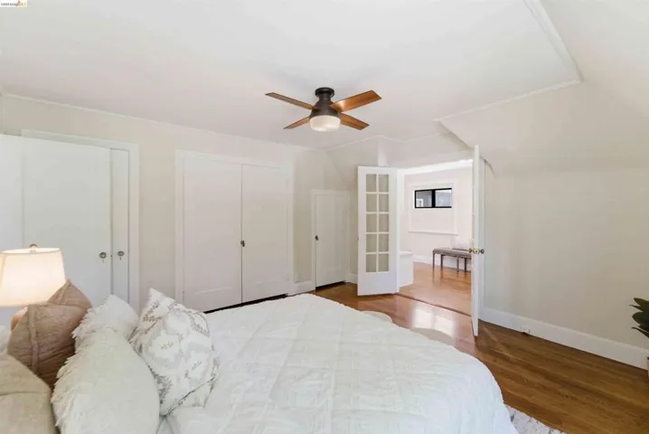 Bedroom featuring wood-finish flooring and a ceiling fan with integrated lighting