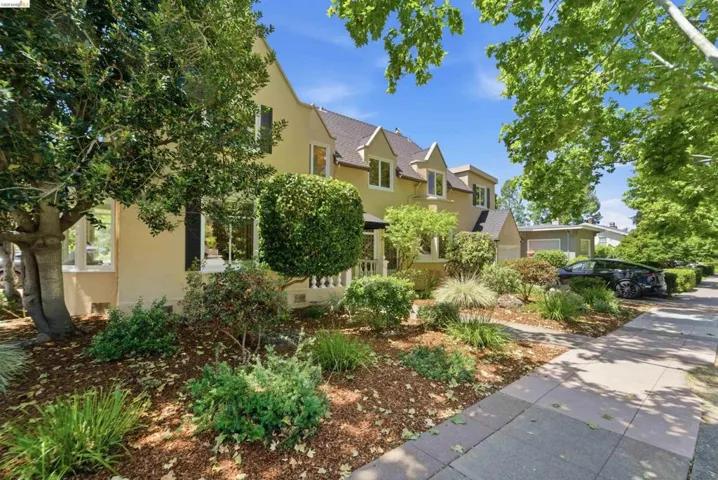 Exterior featuring a light-colored stucco finish and multiple dormer windows