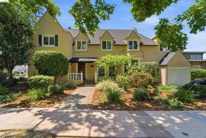 Stucco exterior with multiple gables and a dark shingle roof
