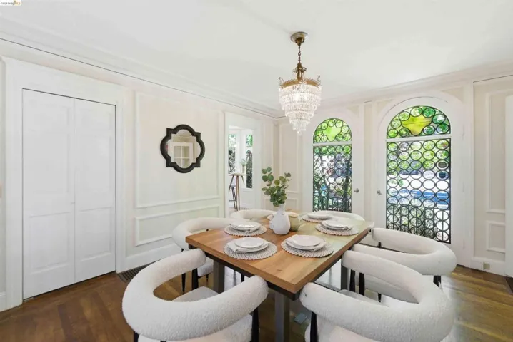 Dining area featuring two arched doors with decorative grilles and stained glass accents