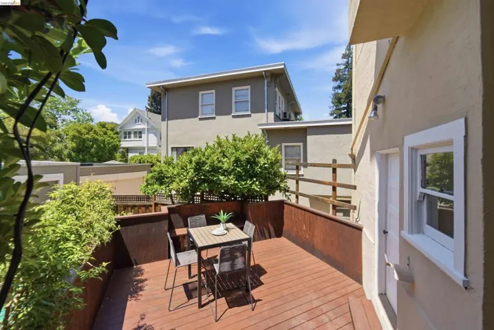 Expansive wood deck with rich-toned privacy fencing and mature landscaping