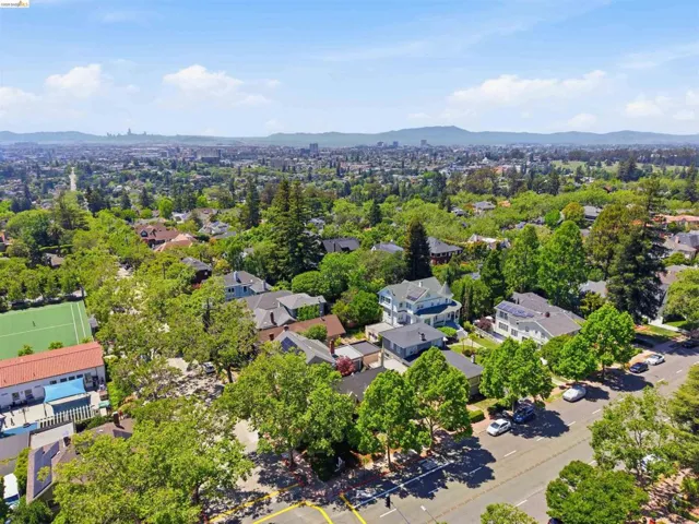 Aerial perspective showcasing a residential area with mature trees and varied architectural styles