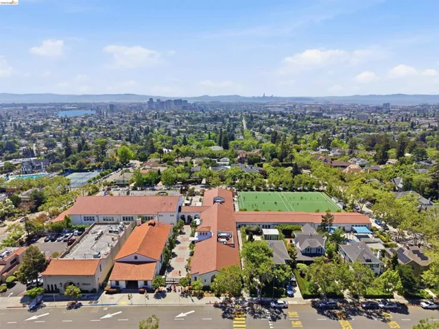 Expansive urban landscape with a prominent complex of buildings featuring terracotta-style roofing