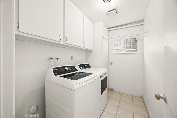 Separate Laundry room with cabinets