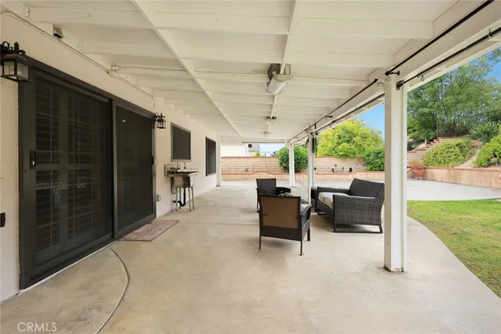 Large covered patio across the back of the home with Crimsafe steel mesh screens on rear windows & sliding door