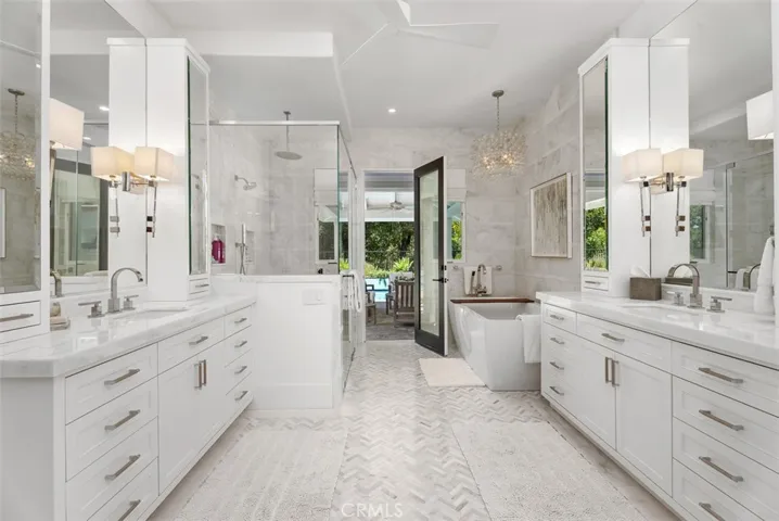 Primary bathroom includes separate vanities, soaking tub, walk-in shower and sit down vanity (not pictured)