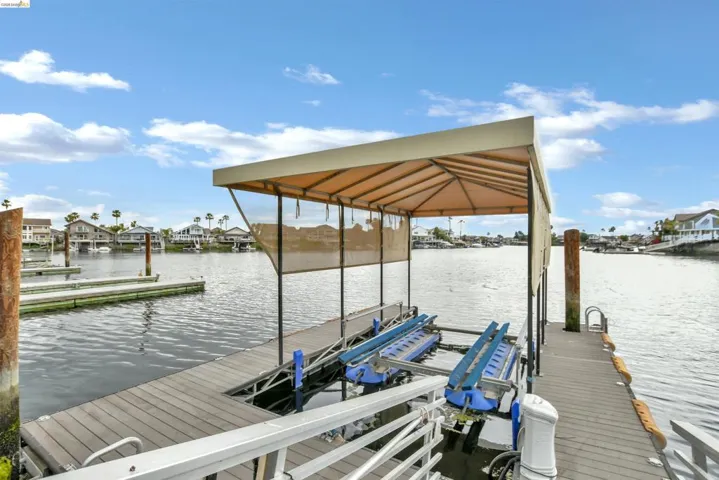 Private dock with covered boat lift and composite decking