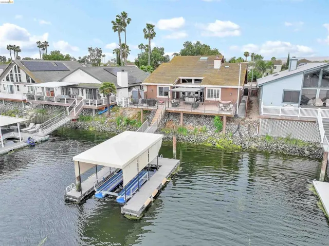 Waterfront property featuring a private boat dock with a covered slip and direct water access