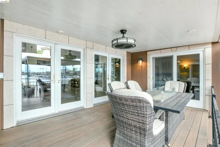 Covered outdoor balcony featuring wood-finish flooring