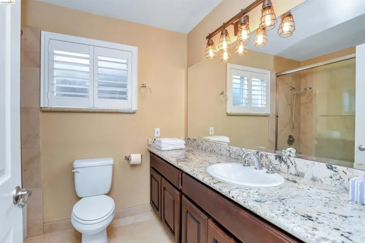 Expansive vanity with a stone countertop and integrated sink