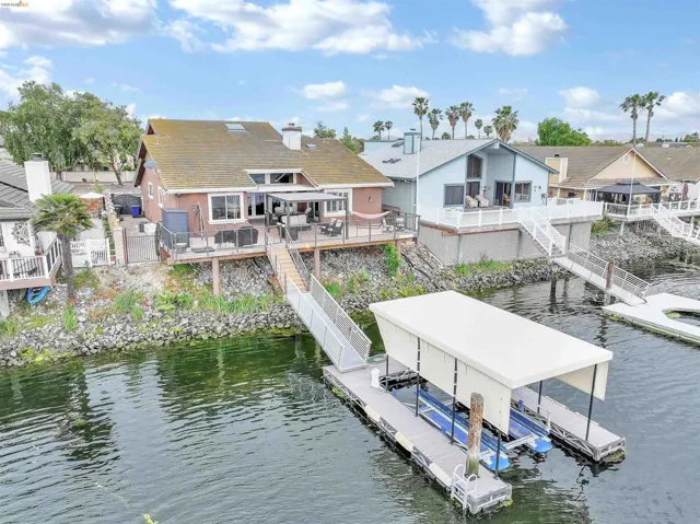 Waterfront property featuring a private boat dock with covered slip and direct water access