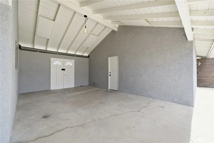 Private rear yard with covered breezeway offering multiple usable areas for outdoor enjoyment.