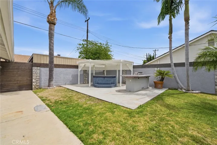 Private backyard designed for casual dining, relaxing, and entertaining. Notice the additional fencing on top of the block walls for added privacy.