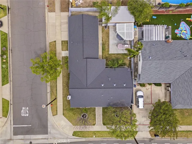 Drone view showcasing the covered side parking and rear yard layout.