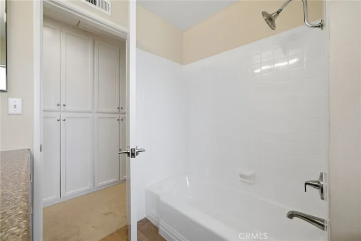 Full hallway bathroom with resurfaced shower and tub combination.