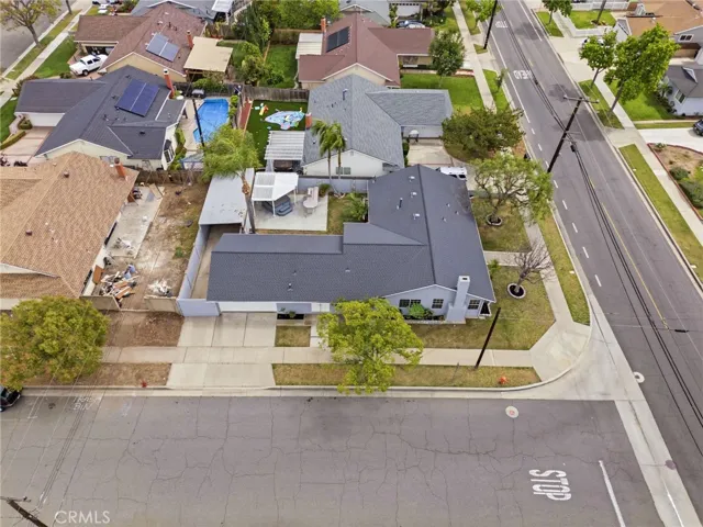 Aerial view highlighting the spacious corner lot and surrounding neighborhood. Please note that the house behind the subject property is being remodeled, hence the condition of their backyard.