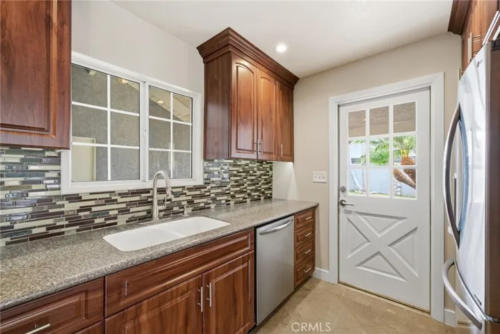 Mosaic-style backsplash adds texture and detail to the kitchen design.