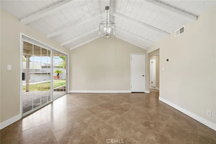 Dining area offers direct access to the backyard through sliding doors + vaulted ceilings!
