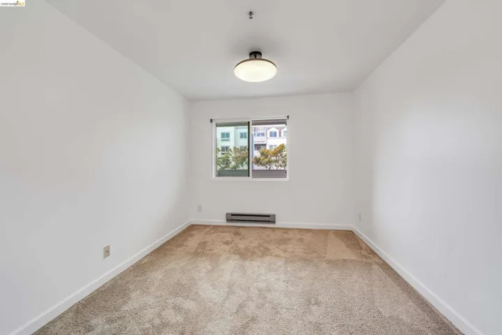 Neutral wall paint and carpeted flooring define this room