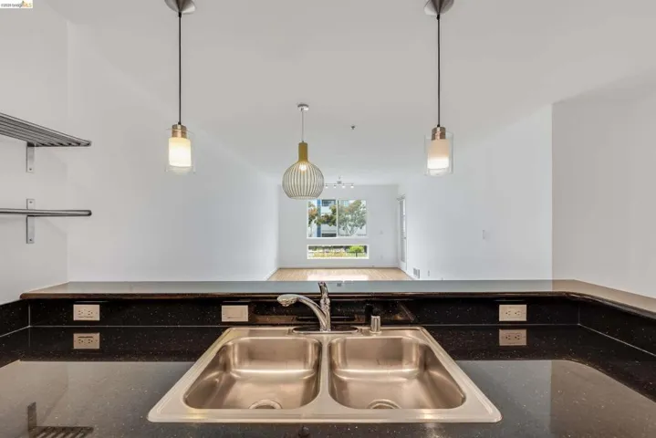 Kitchen counter with a dual basin stainless steel sink and a gooseneck faucet