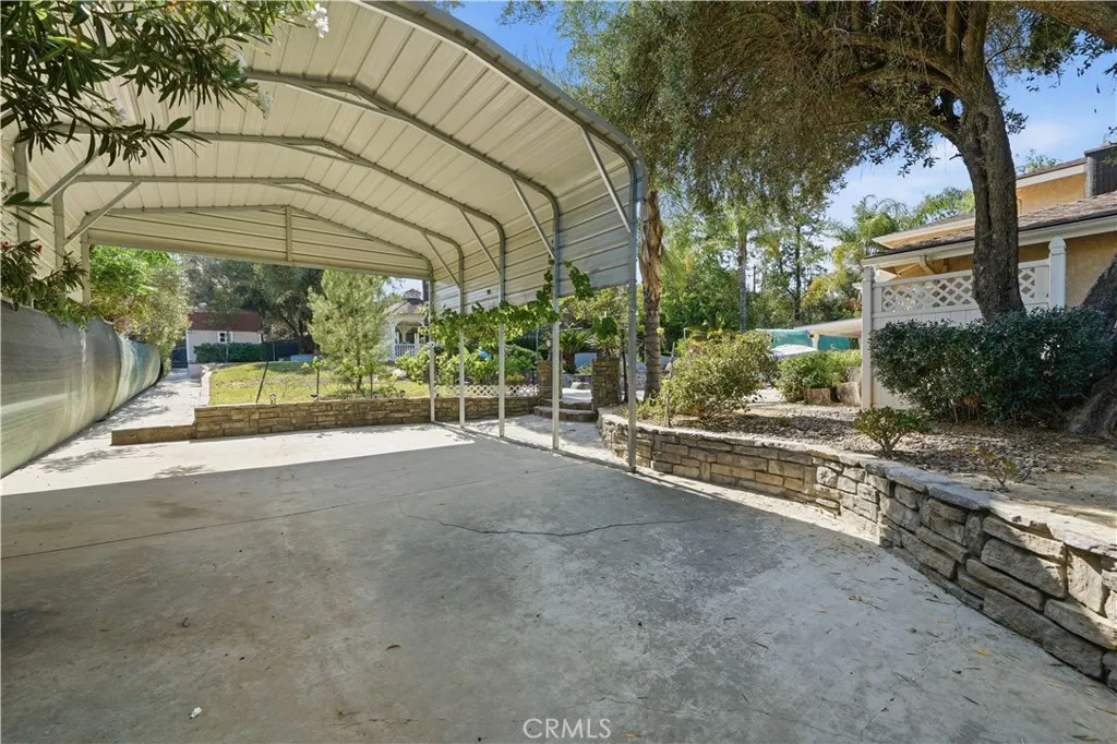 Covered RV or boat storage sits to the side of the property.