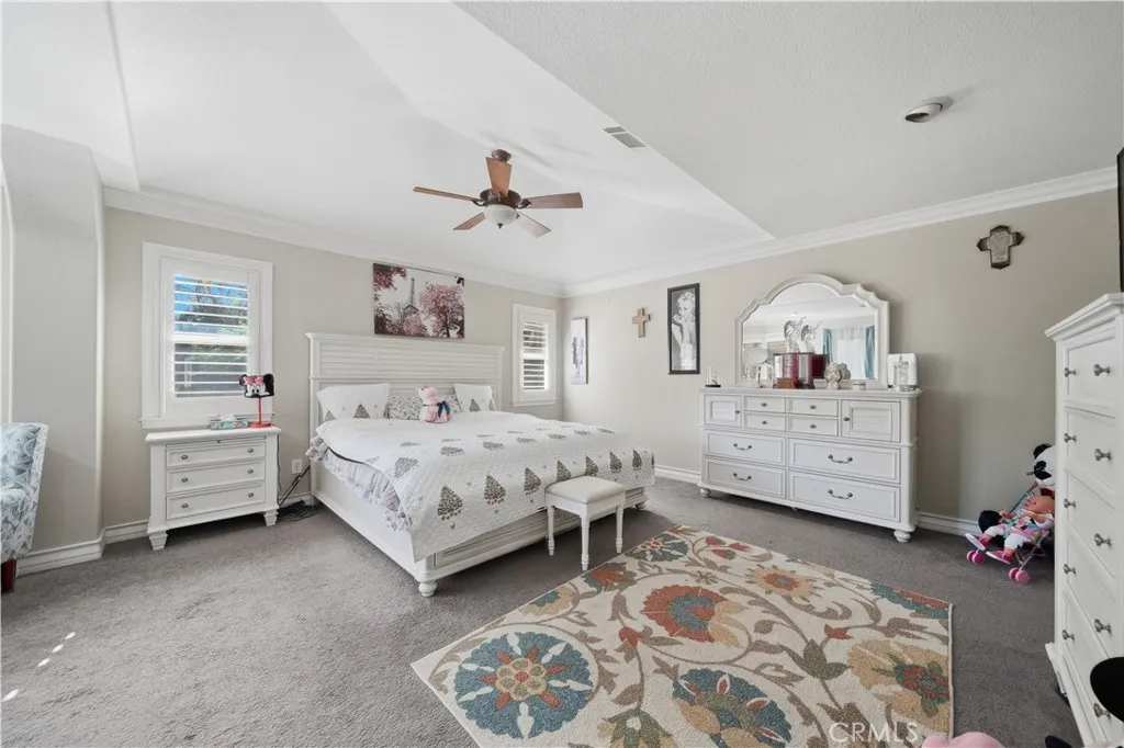 Second floor master bedroom with vaulted ceilings and an extra seating area with double sided fireplace