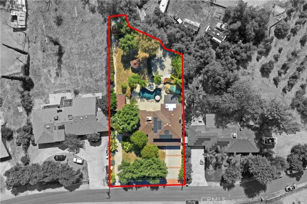 Aerial overview with approximate property lines. Property has large driveway, a separate RV driveway and RV covered and gated area, along with pool, elevated spa, basketball court, gazebo and large shed at the back of the property.