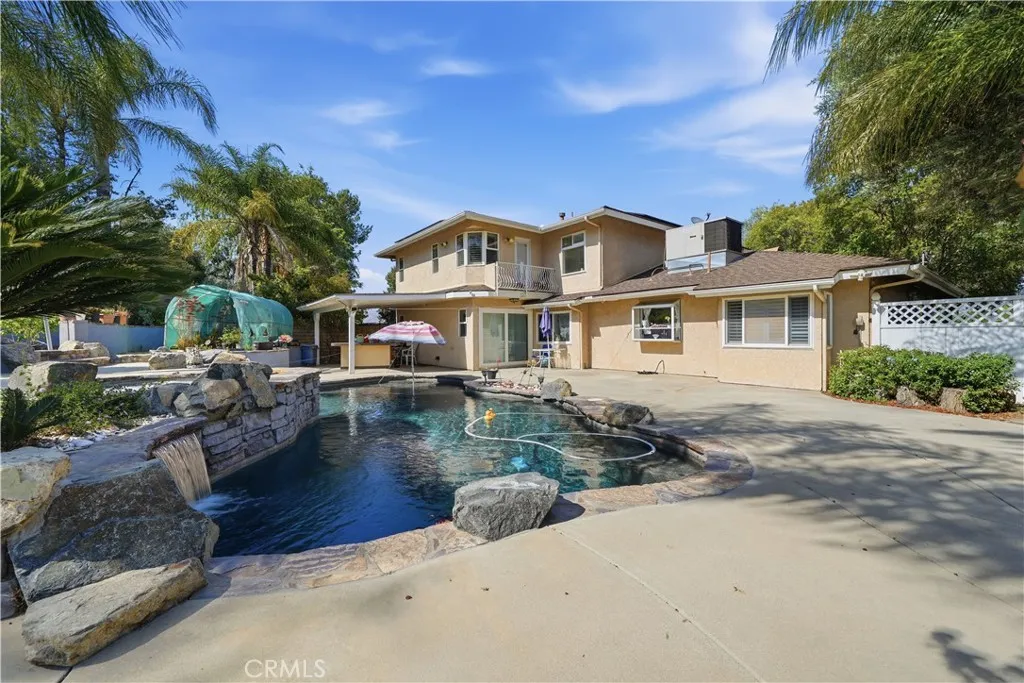 Freeform pool with flagstone coping and natural stone boulders.