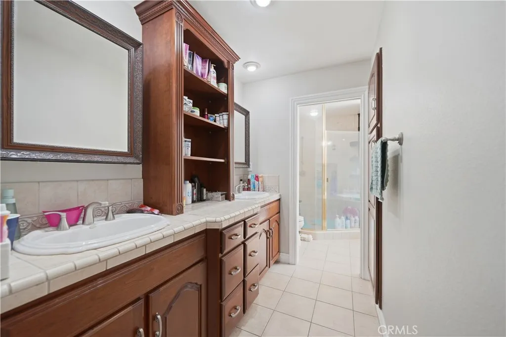 Master bathroom offerings dual sinks and plenty of extra storage with linen cabinets built in