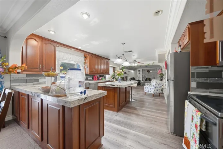 Kitchen features upgraded cabinets, peninsula and island with granite counter tops