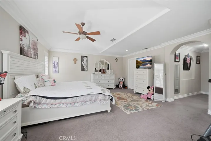 Elegant master bedroom with entry hall and attached bathroom.