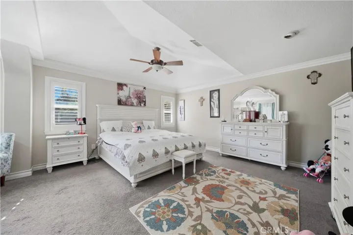 Second floor master bedroom with vaulted ceilings and an extra seating area with double sided fireplace