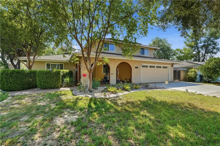 Large mature trees shade the front yard.