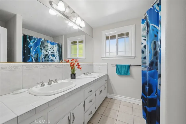 Second floor hall bathroom with dual sinks and a tub/shower combo