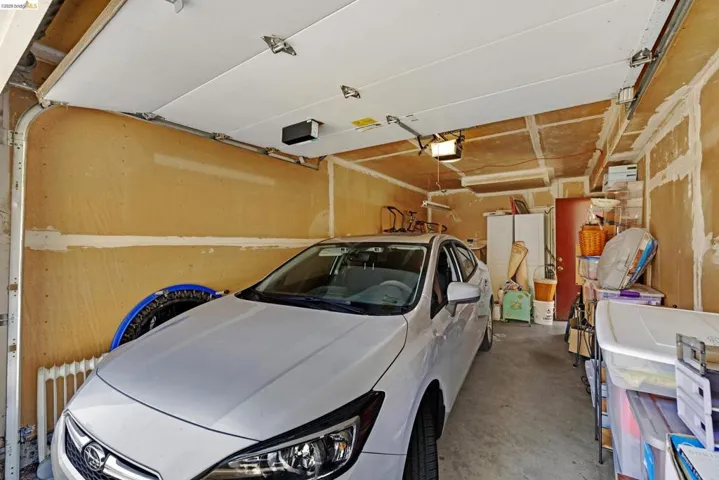 Single-car garage featuring a concrete floor and an overhead garage door