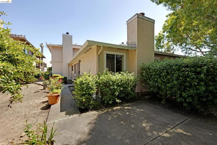 Exterior stucco finish with a prominent chimney structure