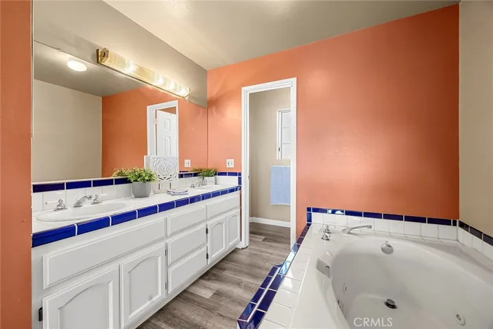 Bathroom #3 - Primary bedroom en suite full bathroom with dual vanity sink, soaking jacuzzi tub and separate shower and toilet with door.