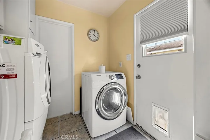 Separate laundry room, door on left is bathroon, door in right is access to side of house, where dog run is located.