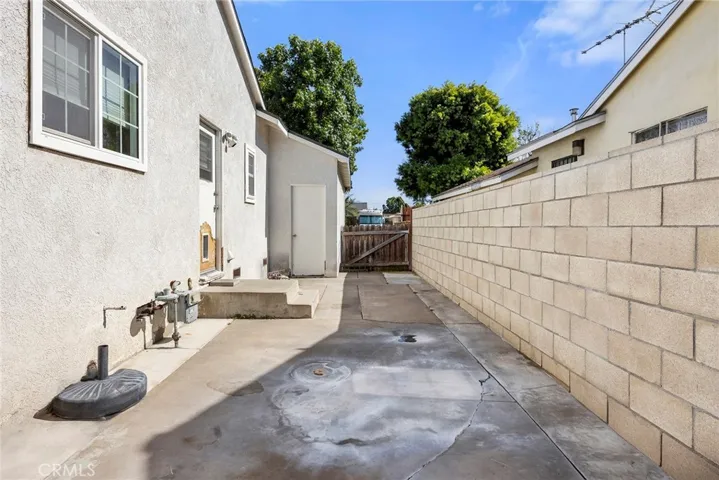 Side of house, door on left goes to laundry room and Kitchen.