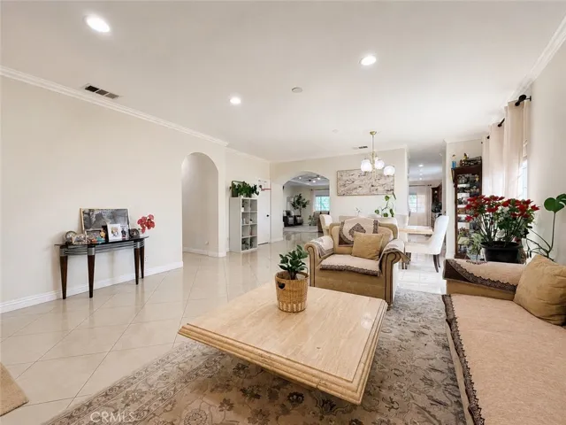 Living room with arched door to the hallway of the bedrooms and small doorway to kitchen/Butler's pantry/walk-in pantry