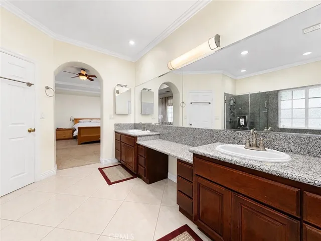 Primary ensuite bath with double sinks and prep vanity