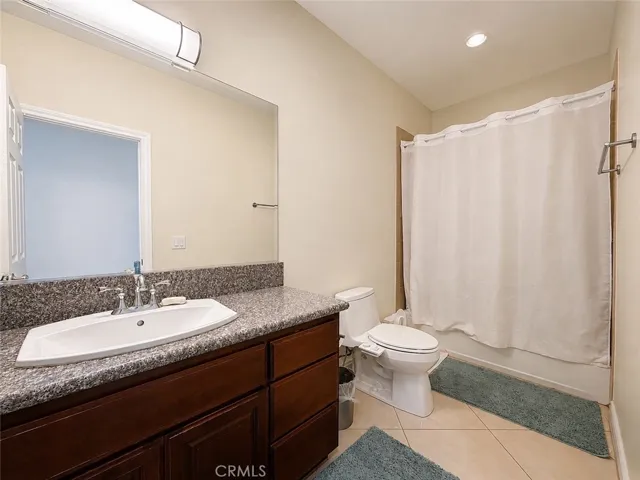 Additional main bathroom with single sink, tub, shower