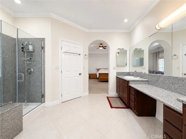 Primary ensuite bath with view of shower and door to toilet