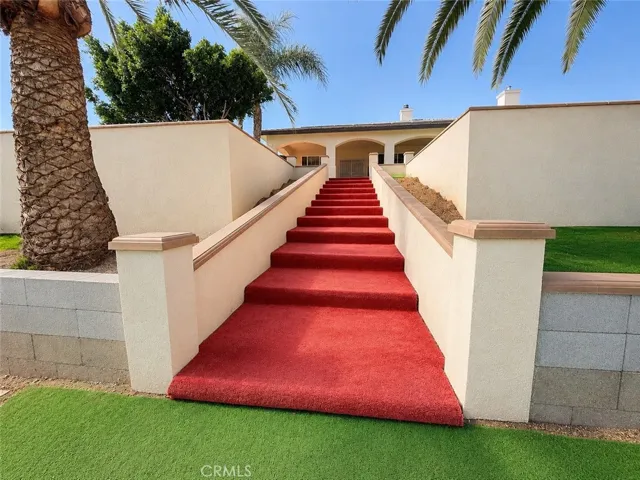 Stairs from top level of terrace (back of home) to lower level of backyard