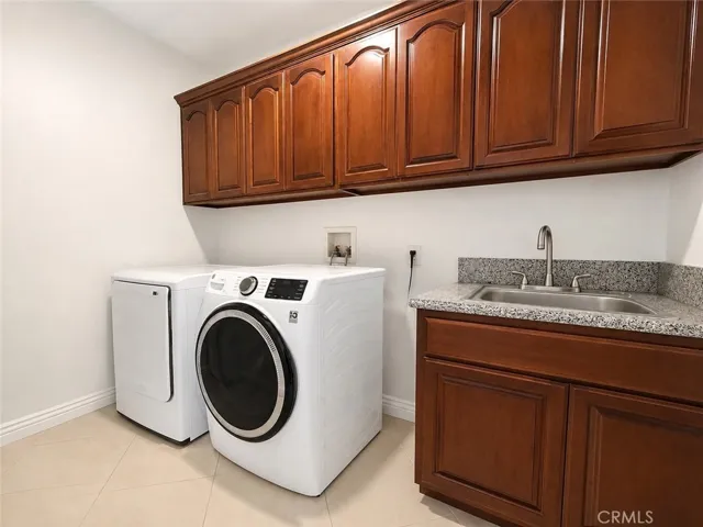 Large laundry room with utility sink